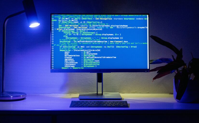 Flatscreen computer display on a desk with a keyboard on it